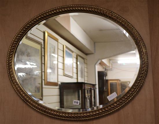 A gilt oval wall mirror W.79cm